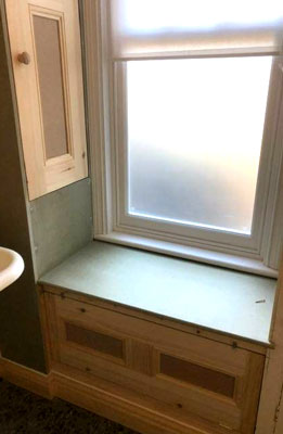 bathroom window seat and storage cupboard  