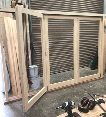 three leaf bifold doors timber in the workshop  