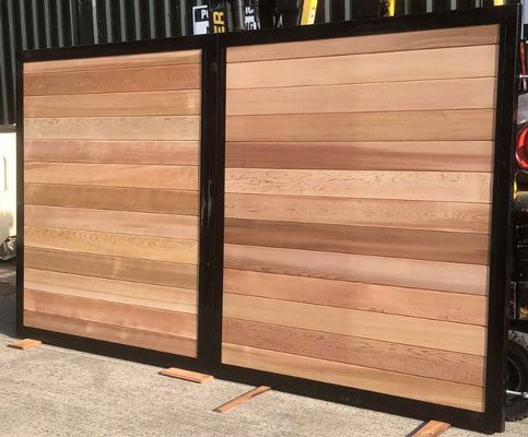 metal framed entrance gate with solid wood boarding