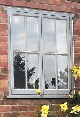 Traditional dual opening timber casment window with four glazed panes